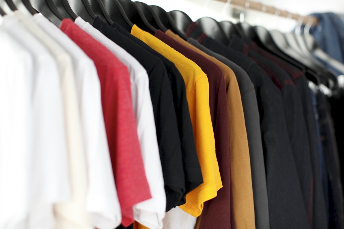Clothing rail with garments on wooden hangers