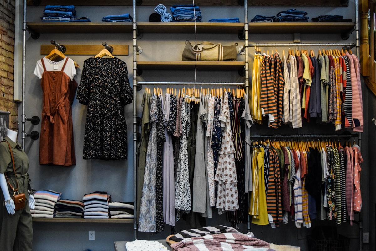 Racks and shelves of folded and hanging clothing in the shop